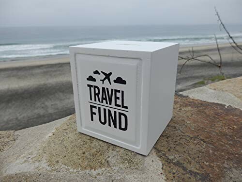 Travel fund box on a beach wall.